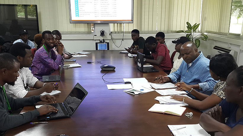 The Director General of IITA, Dr Sanginga screening some of the plans submitted by the youth.