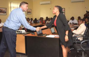 Picture of US Ambassador Stuart Symintgton shaking hands of Evelyn Ohanwusi of IYA. Photo by IITA