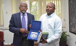 Picture of UofK VC, Professor Ahmed Mohamed Suliman(left) presenting a gift to IITA Director General, Nteranya Sanginga