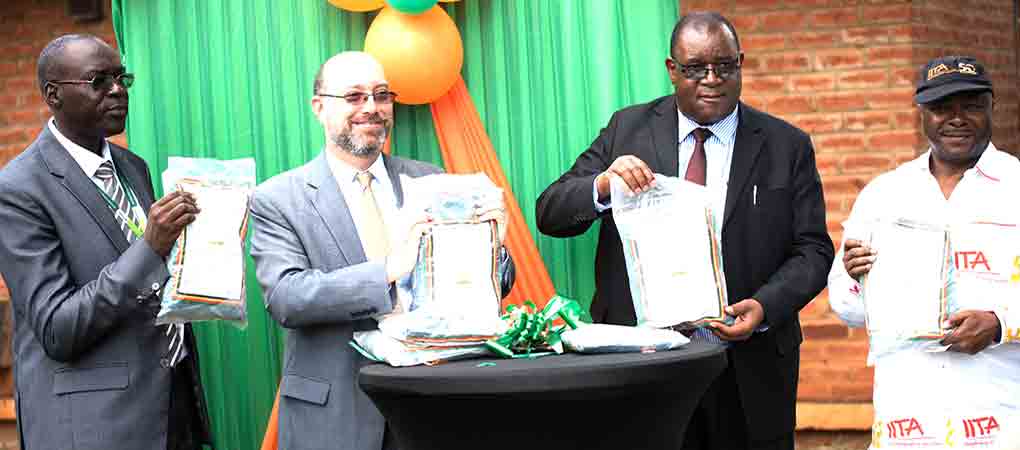 Showing off Aflasafe products: (L-R) MISST Project Advisor, Dr Patrick Okori; US Deputy Chief of Mission, Andrew Hirrup; Controller of Agriculture Services, Dr Alexander Bulirani; and DG Sanginga