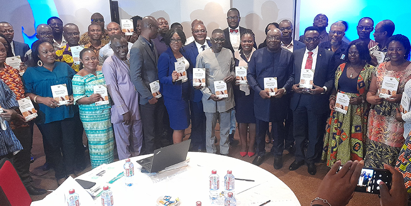 The Minister for Environment, Science, Technology and Innovation, Dr Kwaku Afriyie (front row, sixth from right), with other public and private sector stakeholders showcasing the National Aflatoxin Policy document at the launch event in Accra.