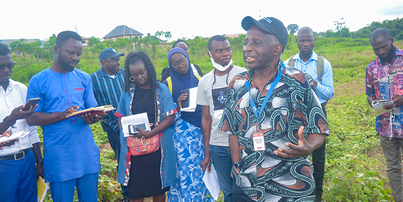 TAAT TAAT Program Management Unit Coordinator Chrys Akem speaking to participating youth at the OFSP demonstration field.