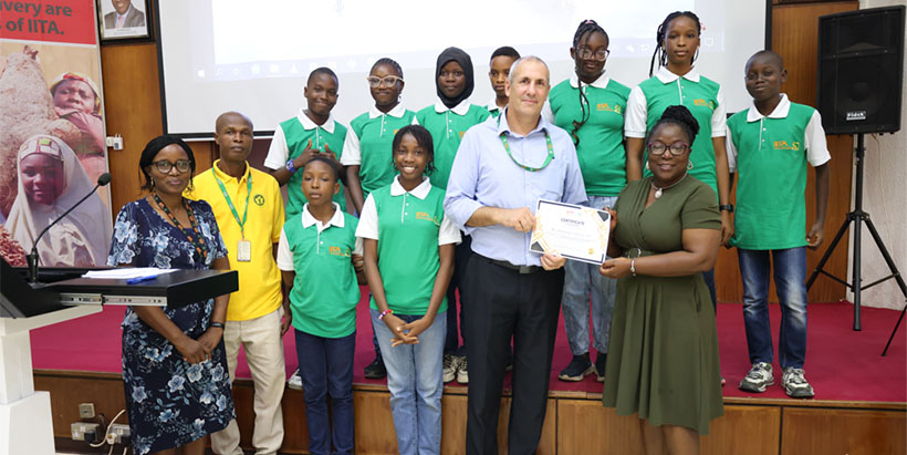 Head of IITA school, Tim Shepherd, presenting a certificate of participation to one of the secondary schools