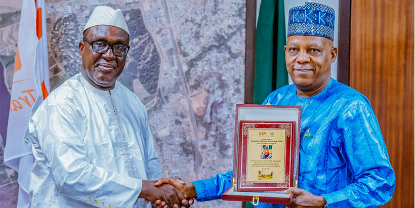 IITA Director General and CGIAR Regional Director for Continental Africa, Dr Simeon Ehui presenting a plague to the Vice President His Excellency Kashim Shettima