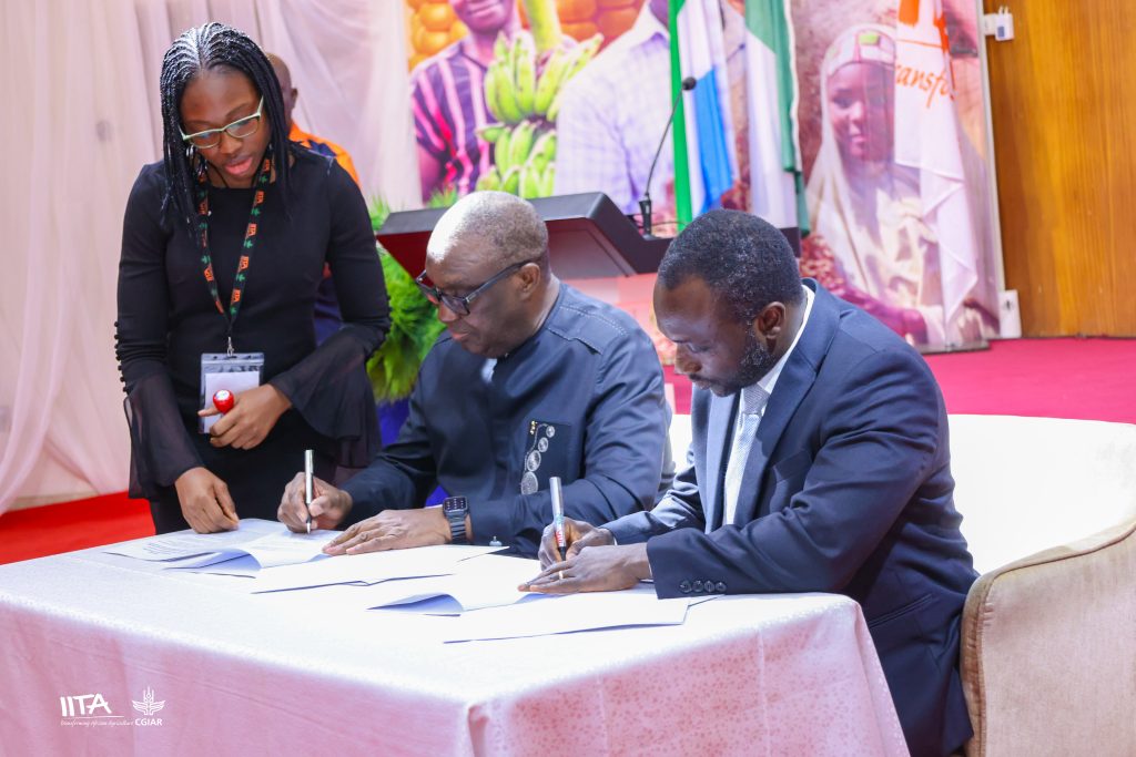 IITA Director General, Dr Simeon Ehui signing the MoU with Sierra Leone Minister of Agriculture and Food Security Dr Henry Musa Kpaka, while IITA Senior Legal Officer Precious Adebanjo looks on.