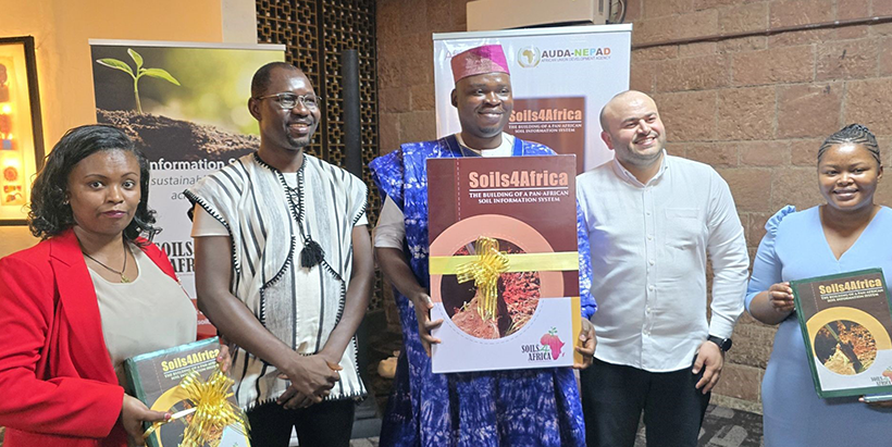 Dr Samuel Mesele holding the legacy product of Soils4Africa along with other stakeholders during the launch.