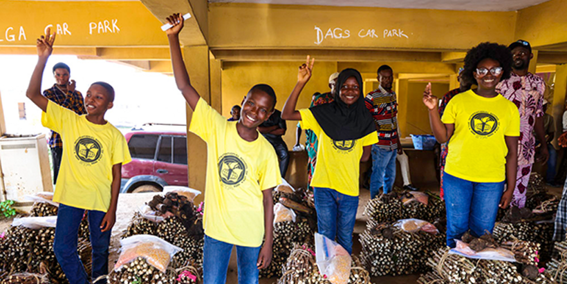 Joshua Ayankanmi and his classmates happy to donate improved planting materials to Akinyele farmers.