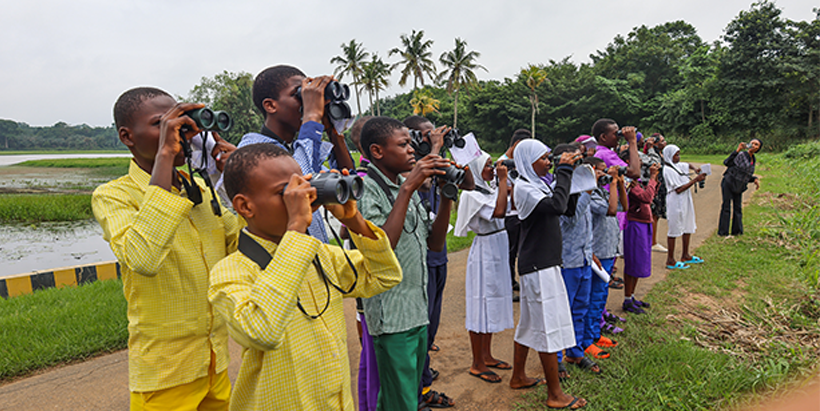 Students of Pade School of Science and Community High School, Ajibade having the bird-watching experience during the camping.