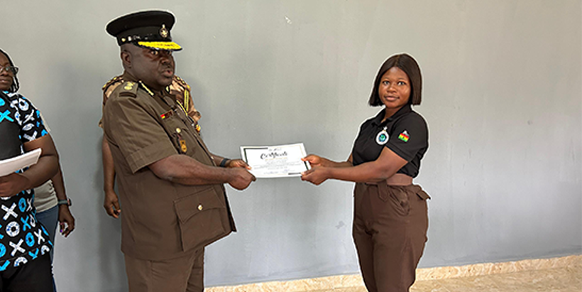 The Director of Prisons Service In-Charge of Agric, Kweku Ababio Ali presenting the certificate to one of the trainees.