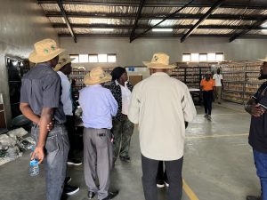 IITA Cassava Breeder gives a the delegation a tour of the soybean storage shed.