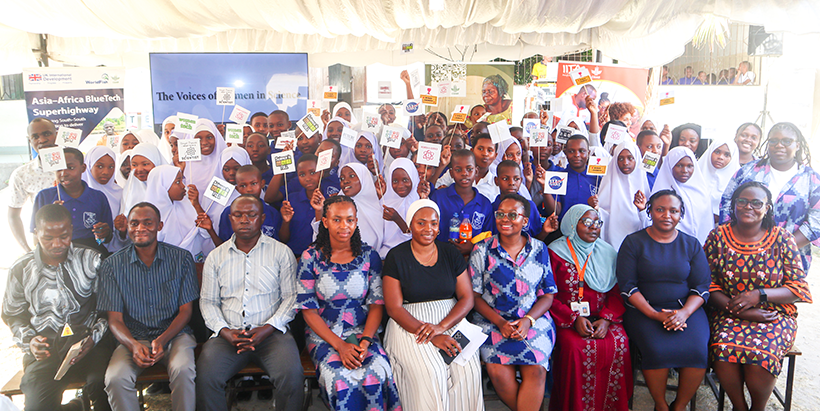 Teachers of Mikocheni Secondary School with CGIAR staff and the students in the background.