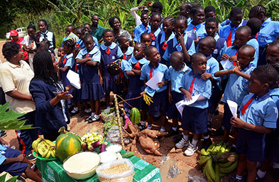 Starting them young: Youth trainer talks to pupils in a primary school in Nigeria about agriculture.